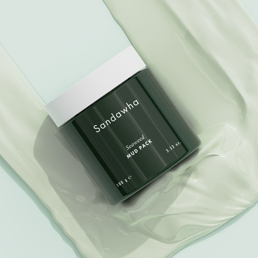 SANDAWHA Seaweed Mud Pack 100g : pack de boue algues dans un pot noir sur fond crème, marque visible.