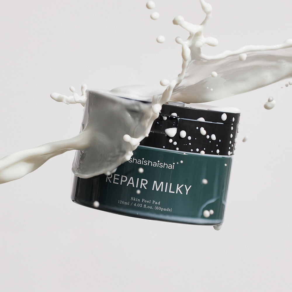SHAISHAISHAI Repair Milky Skin Peel Pad 60 Pads 120ml, marque en flacon noir, lait/pulpe blanche éclaboussures sur fond clair.