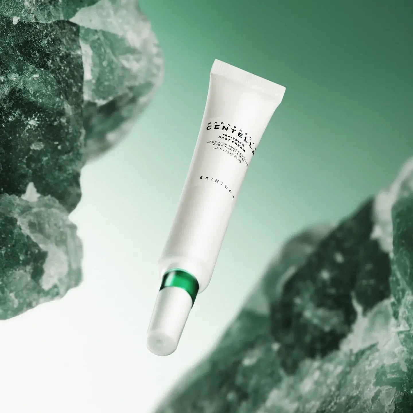 SKIN1004 Madagascar Centella Tea-trica Spot Cream 20ml de SKIN1004, tube crème sur fond vert et pierres, contexte beauté.