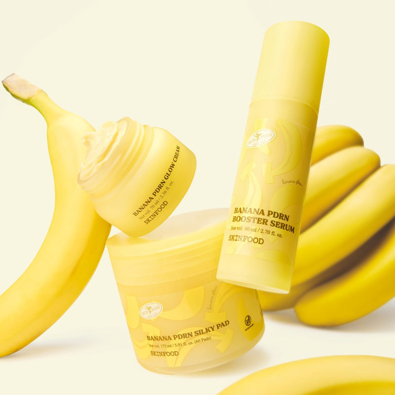 SKINFOOD Banana PDRN Booster Serum 80ml, marque SKINFOOD, flacon jaune près de bananes sur fond clair.
