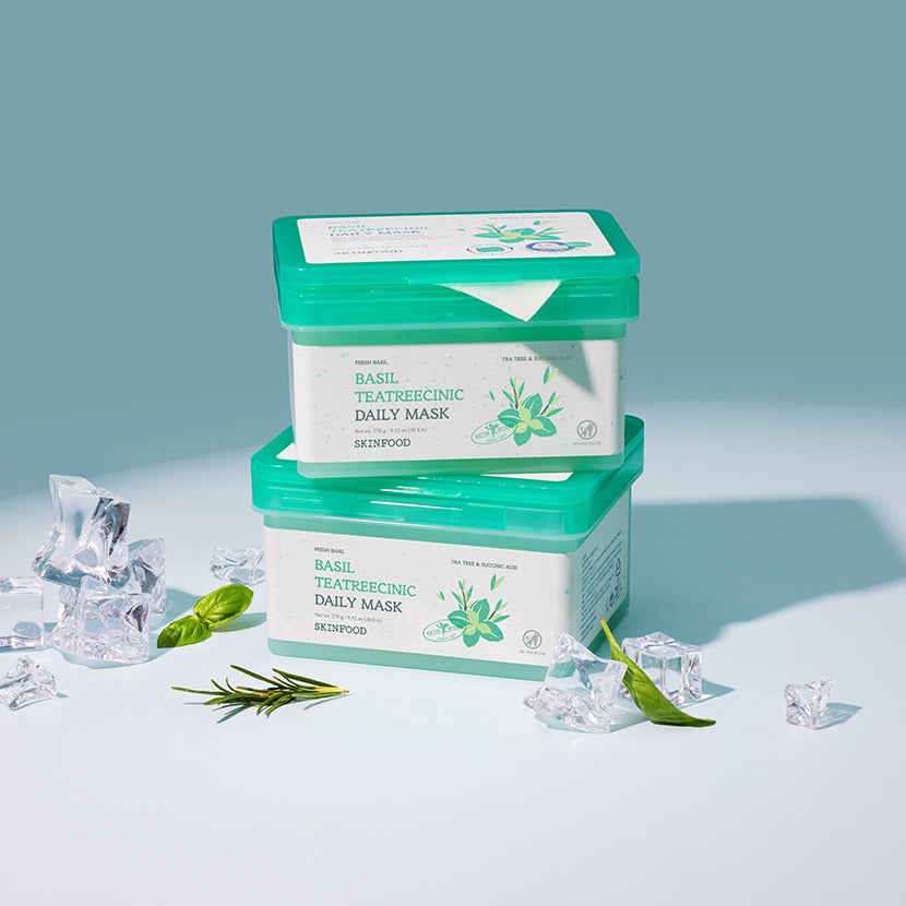 SKINFOOD [NEW] Basil Tea Tree Cynic Daily Mask 30 Sheets : pack vert sur fond bleu, herbes et pochettes