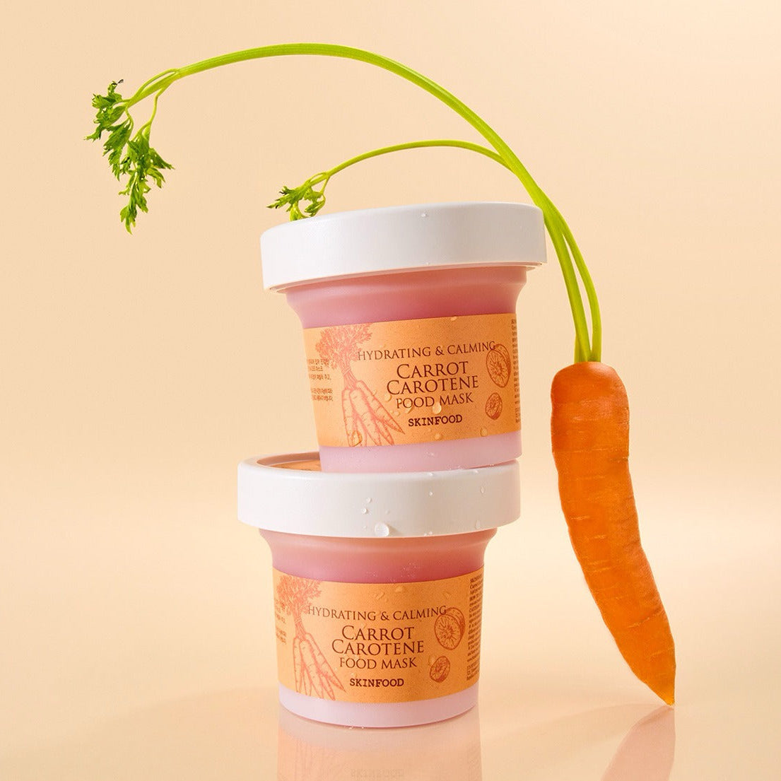 SKINFOOD [NEW ] Carrot Food Mask 120g de SKINFOOD, masques en pots, carotte et tiges vertes sur fond clair