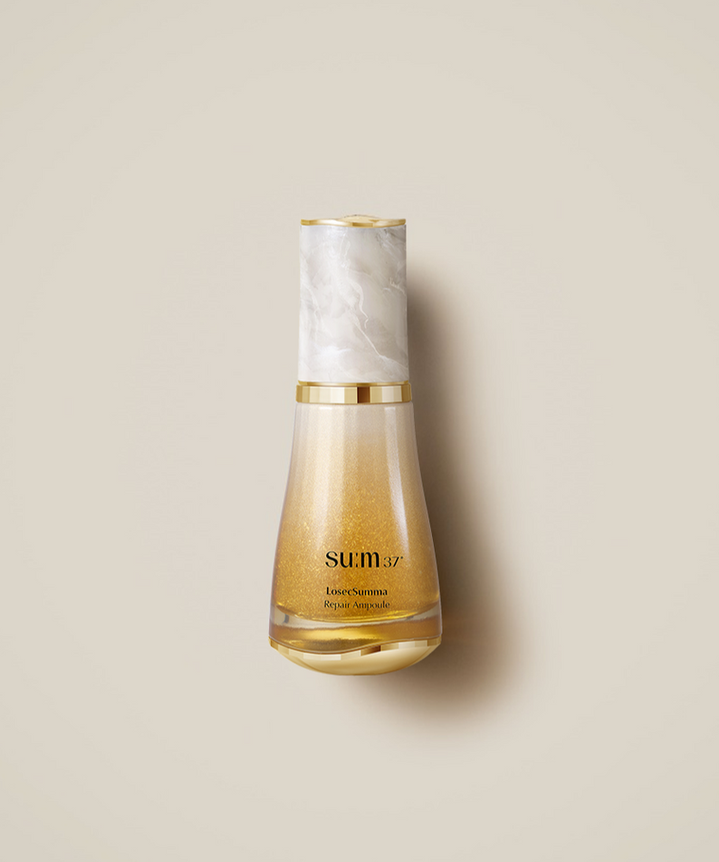SU:M37 LosecSumma Repair Ampoule 50ml, flacon doré sur fond beige, marque SU:M37 visible, produit cosmétique.