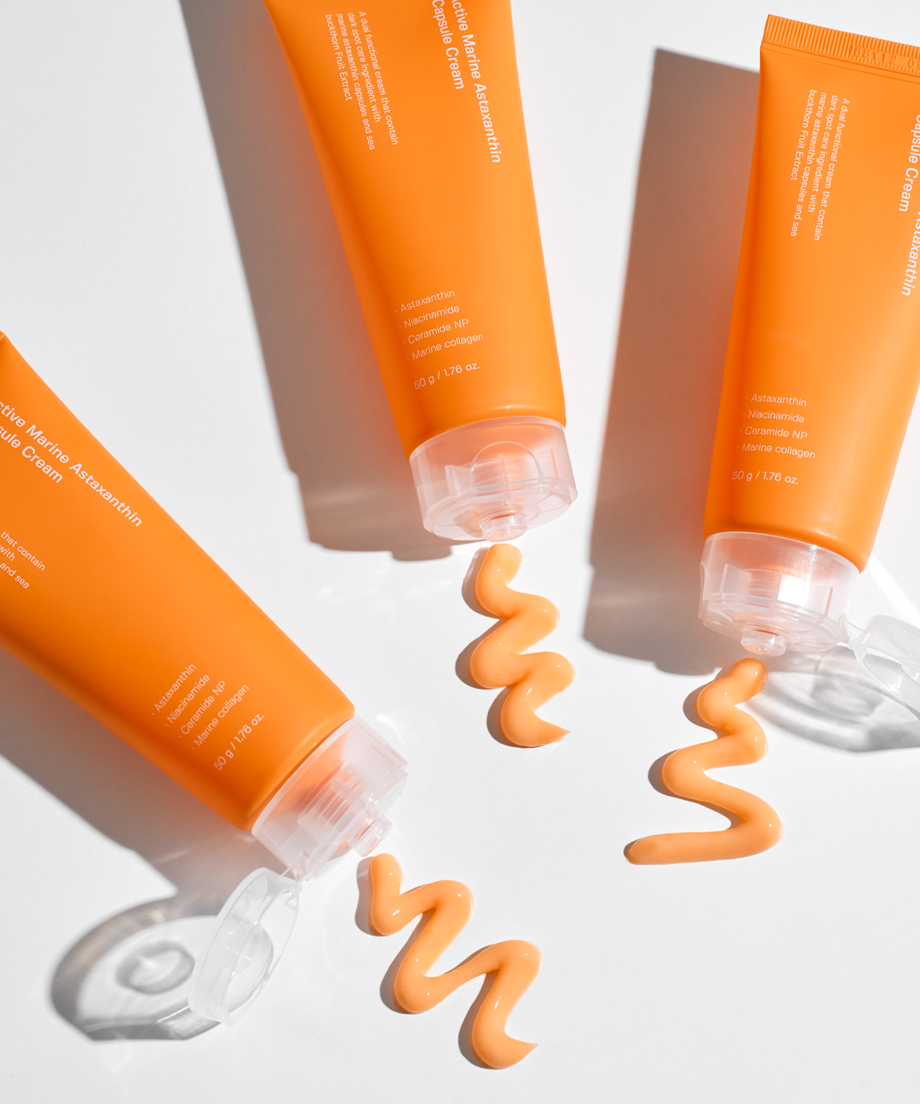 Décris l'image en français : SUNGBOON EDITOR Active Marine Astaxanthin Capsule Cream 50g, tubes orange sur fond blanc.