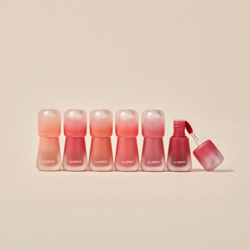 THE SAEM Saemmy's Crema Velvet Tint, pack et flacons dégradés sur fond beige, vue produit cosmétique.