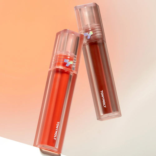 TONY MOLY Perfect Lips Shocking Lip, baume/rouge à lèvres orange, flacons brillants sur fond pêche, marque TONY MOLY