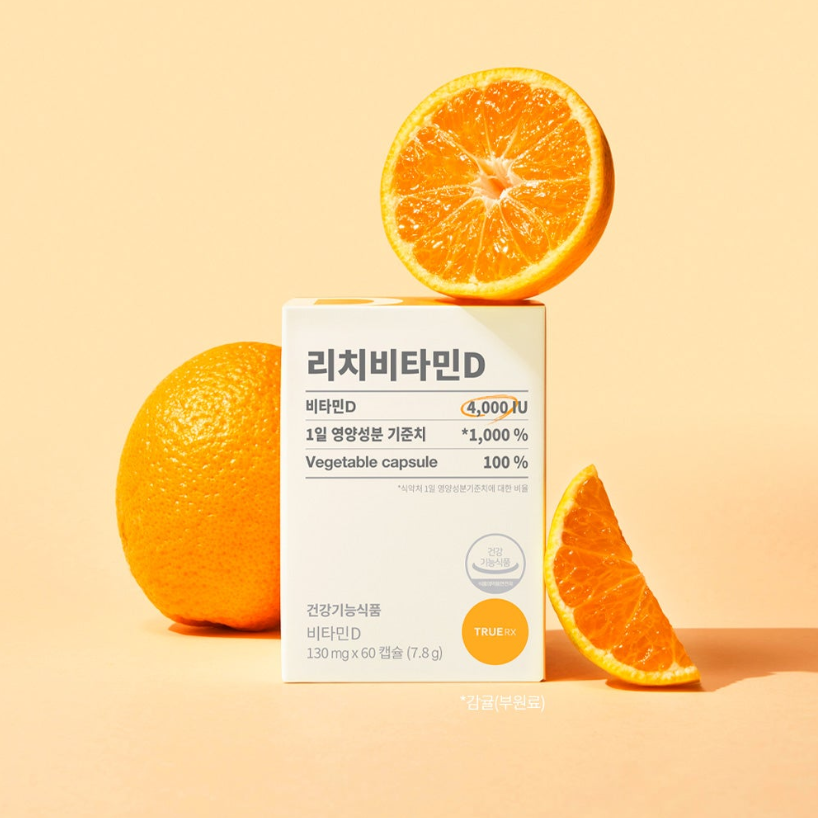 TRUE RX Rich Vitamin D de TRUE RX, boîte près d’oranges sur fond beige, contexte santé vitamine D.