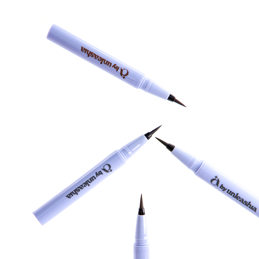 Décris l'image en français : UNLEASHIA the Power Non-Stop Liquid Eyeliner, stylos eyeliner bleu sur fond blanc, marque visible.
