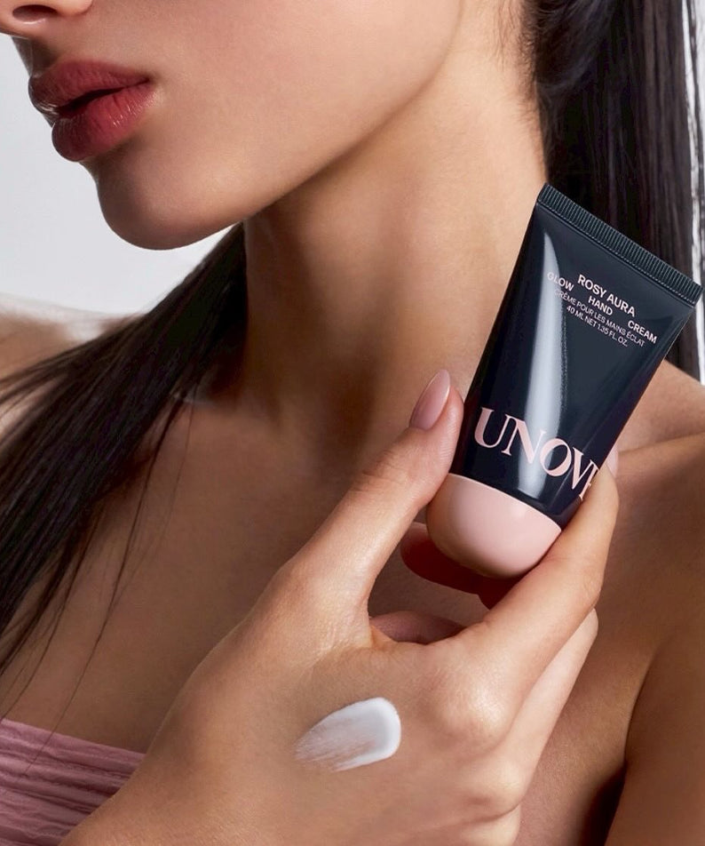Crème pour les mains UNOVE Glow Hand Cream 40ml tenue par une femme, offrant hydratation et éclat naturel à la peau.