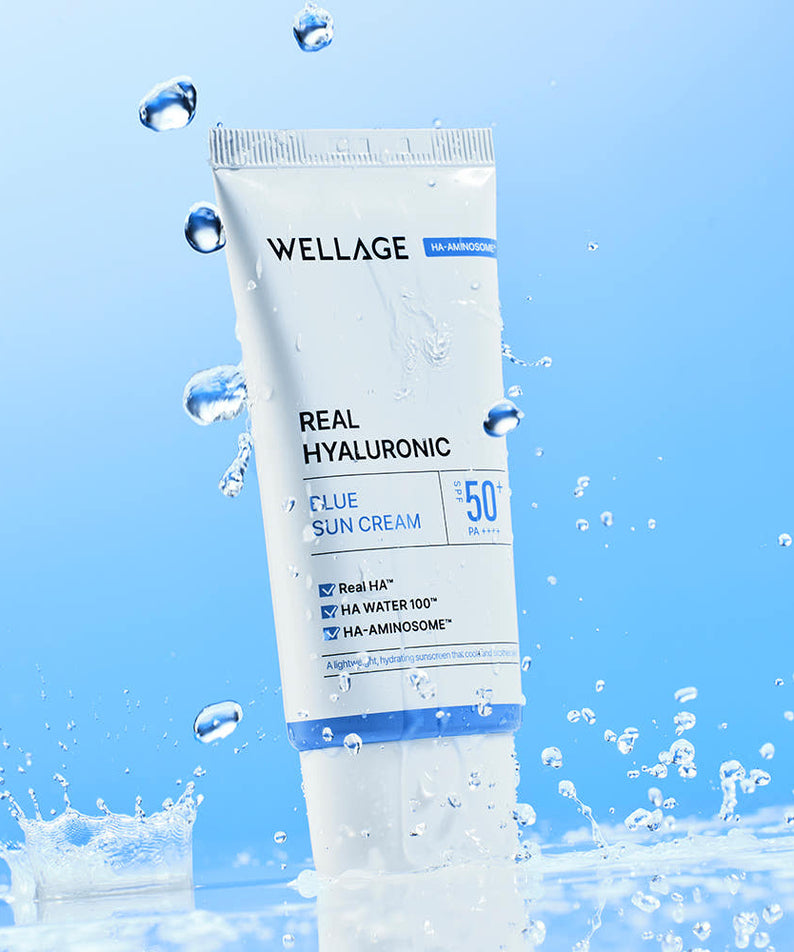 WELLAGE  Real Hyaluronic Blue Sunscreen 50ml : tube cosmétique bleu et gouttes d’eau sur fond clair, marque WELLAGE