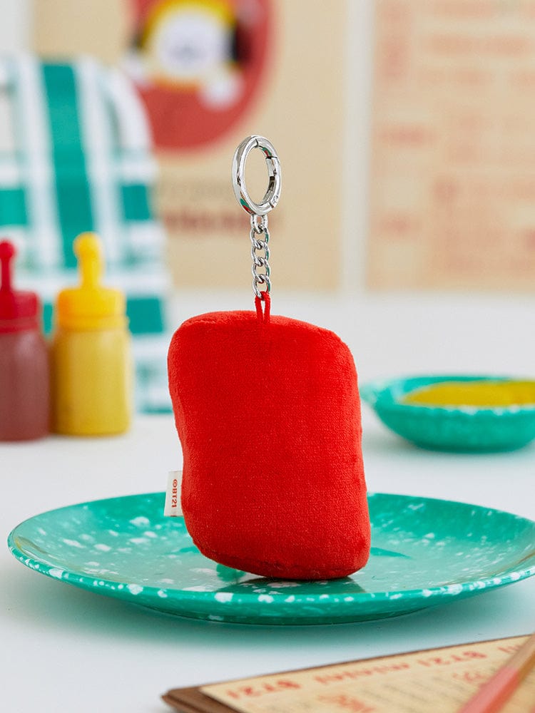 BT21 CHIMMY minini PLUSH KEYRING BUNSIK sur une assiette, porte-clés peluche rouge officiel BT21 en intérieur coloré