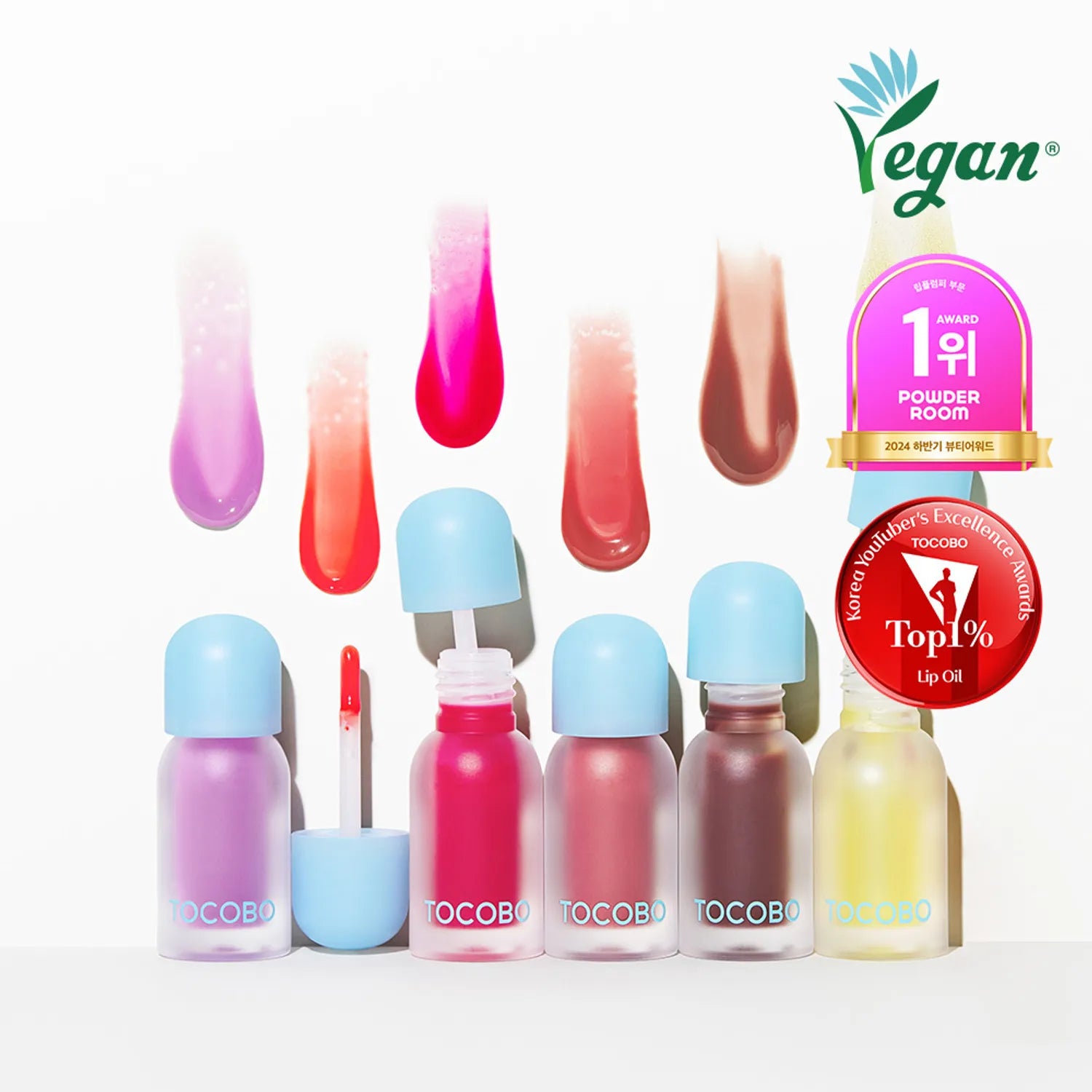 TOCOBO Juicy Berry Pluming Lip Oil de TOCOBO, flacons et applicateurs gouttes, fond clair, visuel vegan et award