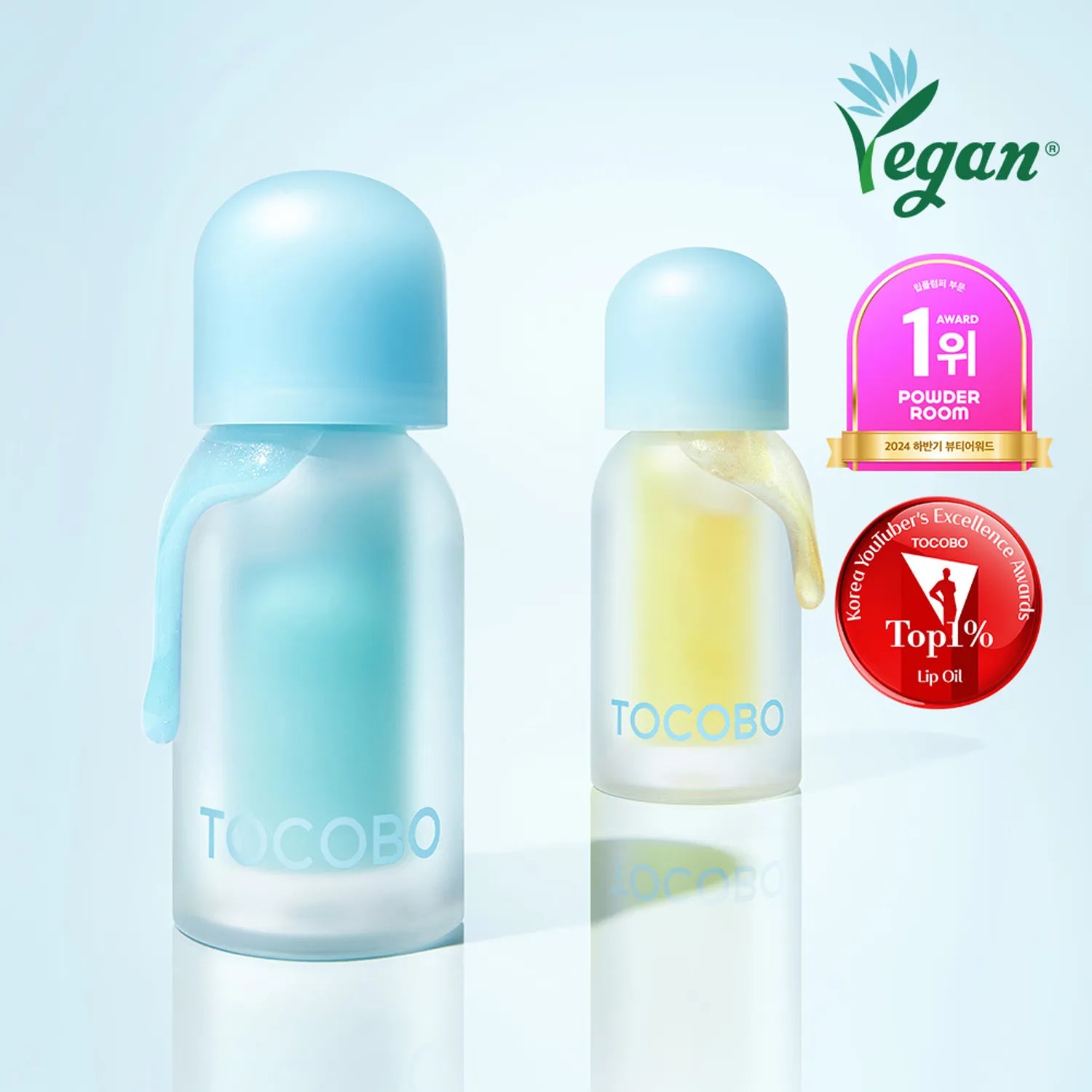 TOCOBO Juicy Berry Pluming Lip Oil de TOCOBO, visuel bleu-rose sur fond clair, flacons à la lumière, vegan
